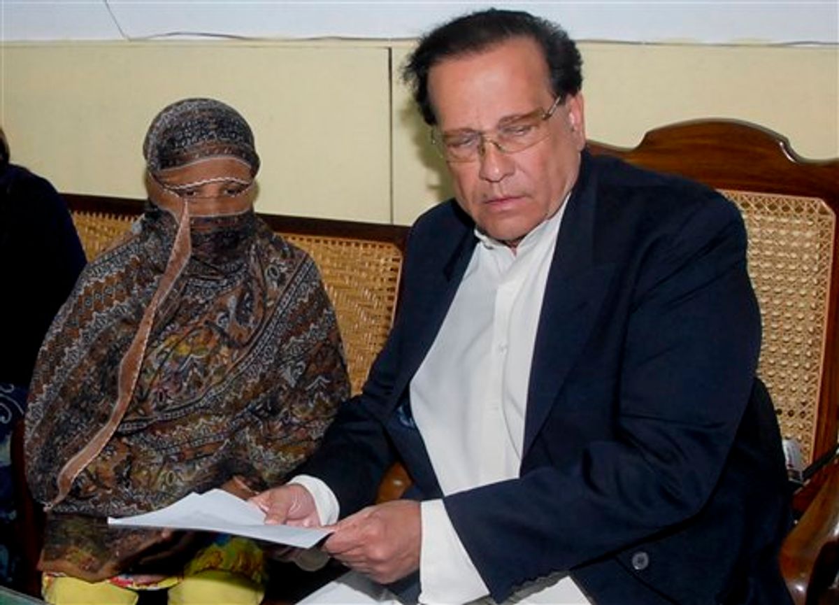 FILE - In this Nov. 20, 2010 file photo, Salman Taseer, right, Governor of Pakistani Punjab Province, listens to Pakistani Christian woman Asia Bibi, left, at a prison in Sheikhupura near Lahore, Pakistan. Taseer was shot dead Tuesday, Jan. 4, 2011,  by one of his guards in the Pakistani capital, apparently because he had spoken out against the country's controversial blasphemy laws, officials said. The killing of Taseer was the most high-profile assassination of a political figure in Pakistan since the slaying of former Prime Minister Benazir Bhutto in December 2007, and it rattled a country already dealing with crises ranging from a potential collapse of the government to Islamist militancy. (AP Photo/File) (AP)