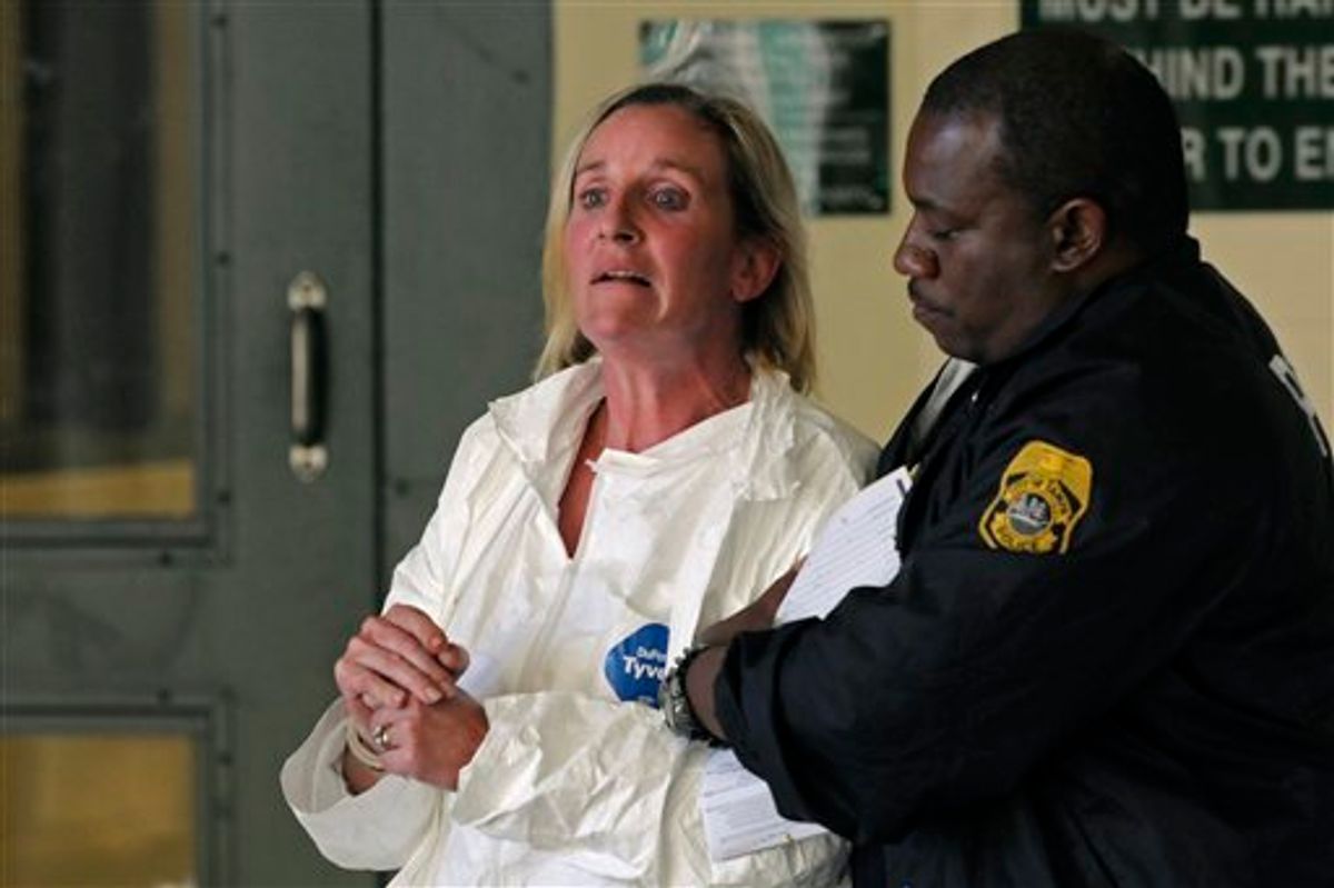 In this Friday, Jan. 28, 2011 photo,  a Tampa Police officer escorts Julie Powers Schenecker to Orient Road Jail on Friday, Jan. 28, 2011 in Tampa, Fla. Police said Julie Powers Schenecker admitted to killing her teenage daughter and son after officers found her covered in blood on the back porch of her home Friday morning, police spokeswoman Laura McElroy said. Schenecker's mother had called police from Texas because she was unable to reach the 50-year-old woman, whom she said was depressed and had been complaining about her children.  (AP Photo/St. Petersburg Times, Bryan Thomas)  TAMPA  OUT; USA TODAY OUT; HERNANDO TODAY OUT; CITRUS COUNTY CHRONICLE  OUT;  NO MAGS;  NO SALES (AP)