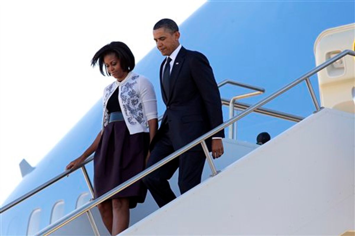 President Barack Obama and first lady Michelle Obama arrive in Tucson, Ariz., to attend a memorial service for victims of last Saturday's shooting rampage that killed six people and left 14 injured, including Rep. Gabrielle Giffords, at Davis-Monthan Air Force Base, Wednesday, Jan. 12, 2011.  (AP Photo/J. Scott Applewhite) (AP)