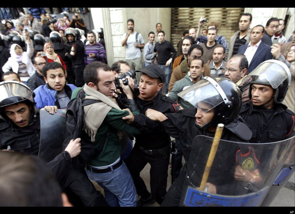 Protesters clash with riot police in Cairo.