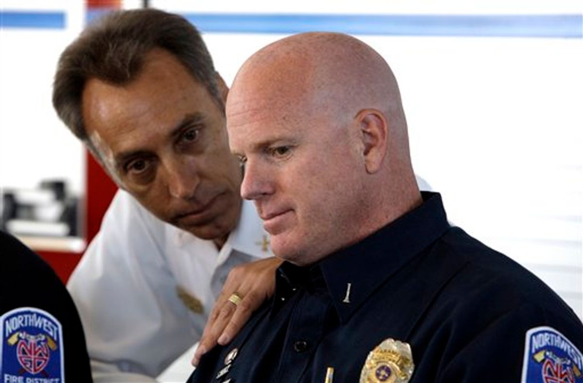 First responders from Northwest Fire District Engine 30 paramedic Tony Compagno, right, who was first on the scene to care for gunshot victim Rep. Gabrielle Giffords, D-Ariz., talks with battalion chief Lane Spalla during a moment of reflection at a Northwest Fire District station Saturday, Jan. 15, 2011, in Tucson, Ariz.  Giffords, who is still in critical condition, was one of 19 victims shot last Saturday, six fatally in a mass shooting. (AP Photo/Ross D. Franklin) (AP)