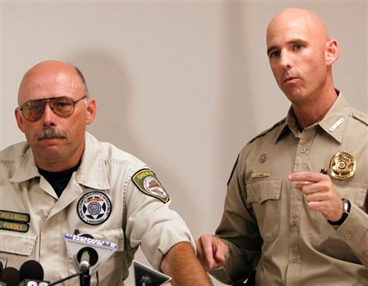 File - This Oct. 7, 2010 file photo shows Pinal County Sheriff's Deputy Louie Puroll, left, during a news conference as Pinal County Sheriff Paul Babeu answers a question, at the Pinal County Sheriff's complex, in Florence, Ariz.  Arizona officials on Monday, Jan. 3, 2011, reopened the investigation into a deputy's explanation of how he was shot in the remote desert south of Phoenix amid speculation it was a hoax timed to enflame the debate over illegal immigration. The Pinal County Sheriff's Office announced its decision Monday after two nationally known forensic pathologists raised questions. (AP Photo/Ross D. Franklin)  (AP)