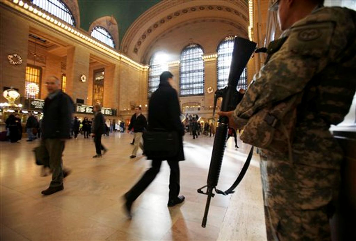 FILE - In this Nov. 24, 2010 file photo, National Guard security personnel watch as travelers make their way through Grand Central Station in New York. As the holiday tourist season begins in the Big Apple, there are reminders everywhere of how being the countrys main target for terrorism has gradually changed this city. (AP Photo/Seth Wenig, File) (AP)
