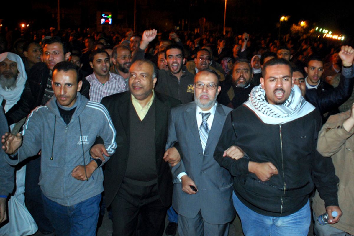 Muslim Brotherhood seniors Essam el-Erian, center right, and Saad el-Katatni, center left, take part in a protest in Cairo, Egypt, Sunday, Jan. 30, 2011. (Mohammed Abu Zaid)