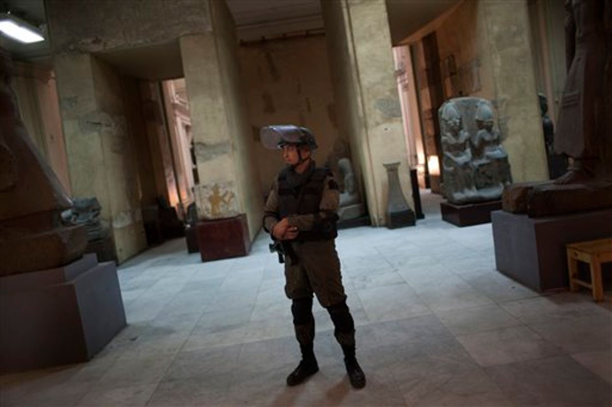 A member of the Egyptian special forces stands guard on the main floor of the Egyptian Museum in Cairo, Egypt, Thursday, Feb. 10, 2011. Would-be looters broke into Cairo's famed Egyptian Museum on Saturday, Jan. 29, ripping the heads off two mummies and damaging about 75 small artifacts before being caught and detained by army soldiers. (AP Photo/Emilio Morenatti) (AP)