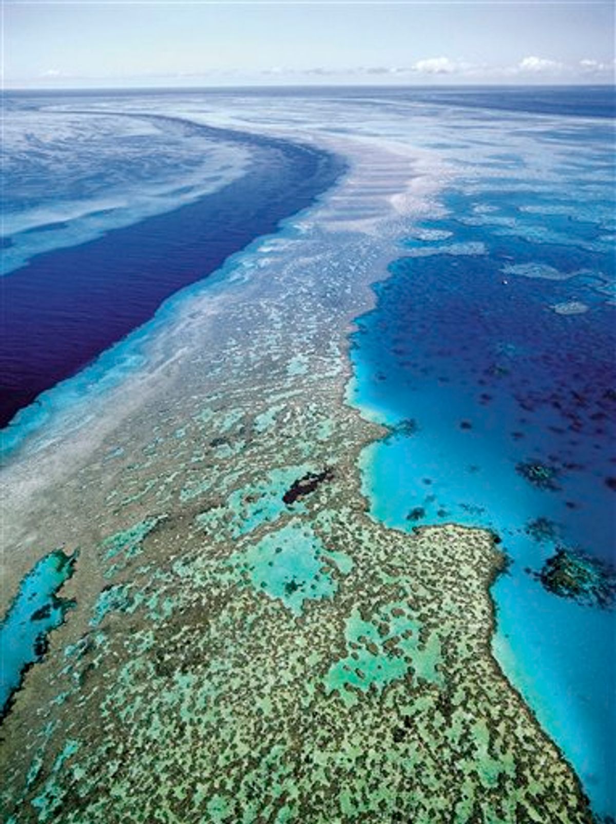 FILE - In this Sept. 2001 file photo provided by Queensland Tourism, the Great Barrier Reef off Australia's Queensland state is shown in an aerial view. Researchers said it is too early to know exactly how much of the reef has been affected by recent flooding, which carved a wide path of destruction on land before draining into the sea off the country's northeast coast. (AP Photo/Queensland Tourism, File)  EDITORIAL USE ONLY  (AP)