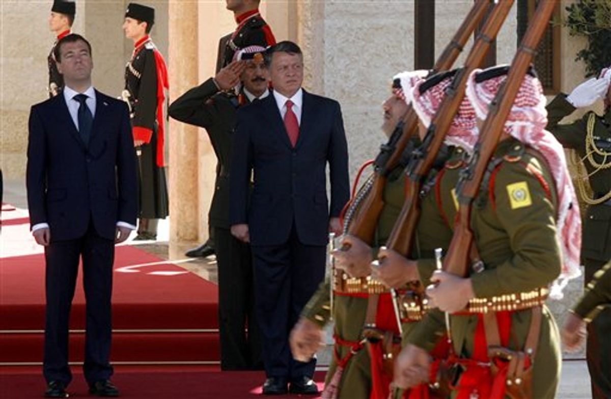 King Abdullah II of Jordan, center, and Russian President Dmitry Medvedev, left, review the Bedouin guards of honor during an official welcoming ceremony prior their talks, in Amman, Jordan, Wednesday, Jan. 19, 2011. (AP Photo/Nader Daoud)  (AP)