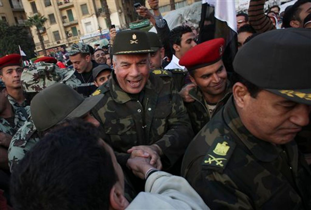 Unidentified  Egyptian army major generals greet people as they walk through Tahrir Square in Cairo, Egypt, Saturday, Feb. 12, 2011. Egypt exploded with joy, tears, and relief after pro-democracy protesters brought down President Hosni Mubarak on Friday with a momentous march on his palaces and state TV. The ruling military pledged Saturday to eventually hand power to an elected civilian government and reassured allies that Egypt will abide by its peace treaty with Israel. (AP Photo/Tara Todras-Whitehill) (AP)