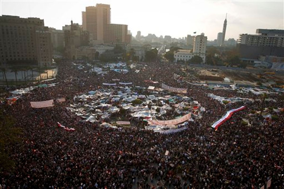 Anti-government protesters demonstrate in Tahrir Square, in Cairo, Egypt, Tuesday, Feb. 8, 2011. Protesters appear to have settled in for a long standoff, turning Tahrir Square into a makeshift village with tens of thousands coming every day, with some sleeping in tents made of blankets and plastic sheeting. The arabic on the sign reads "The rage brings the light of freedom". (AP Photo/Tara Todras-Whitehill) (AP)