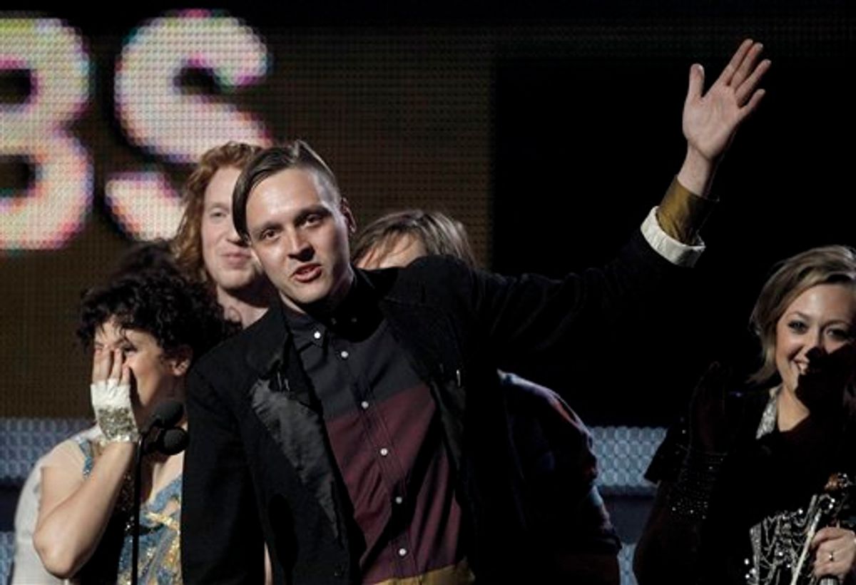 Win Butler, center, is joined by fellow band members of Arcade Fire to accept the award for album of the year at the 53rd annual Grammy Awards on Sunday, Feb. 13, 2011, in Los Angeles. (AP Photo/Matt Sayles)    (AP)