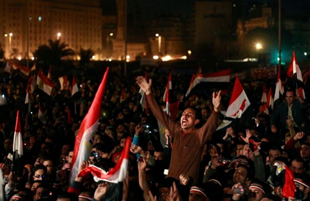 Egyptians celebrate the news of the resignation of President Hosni Mubarak, who handed control of the country to the military, at night in Tahrir Square in downtown Cairo, Egypt Friday, Feb. 11, 2011. (AP Photo/Ben Curtis) (AP)