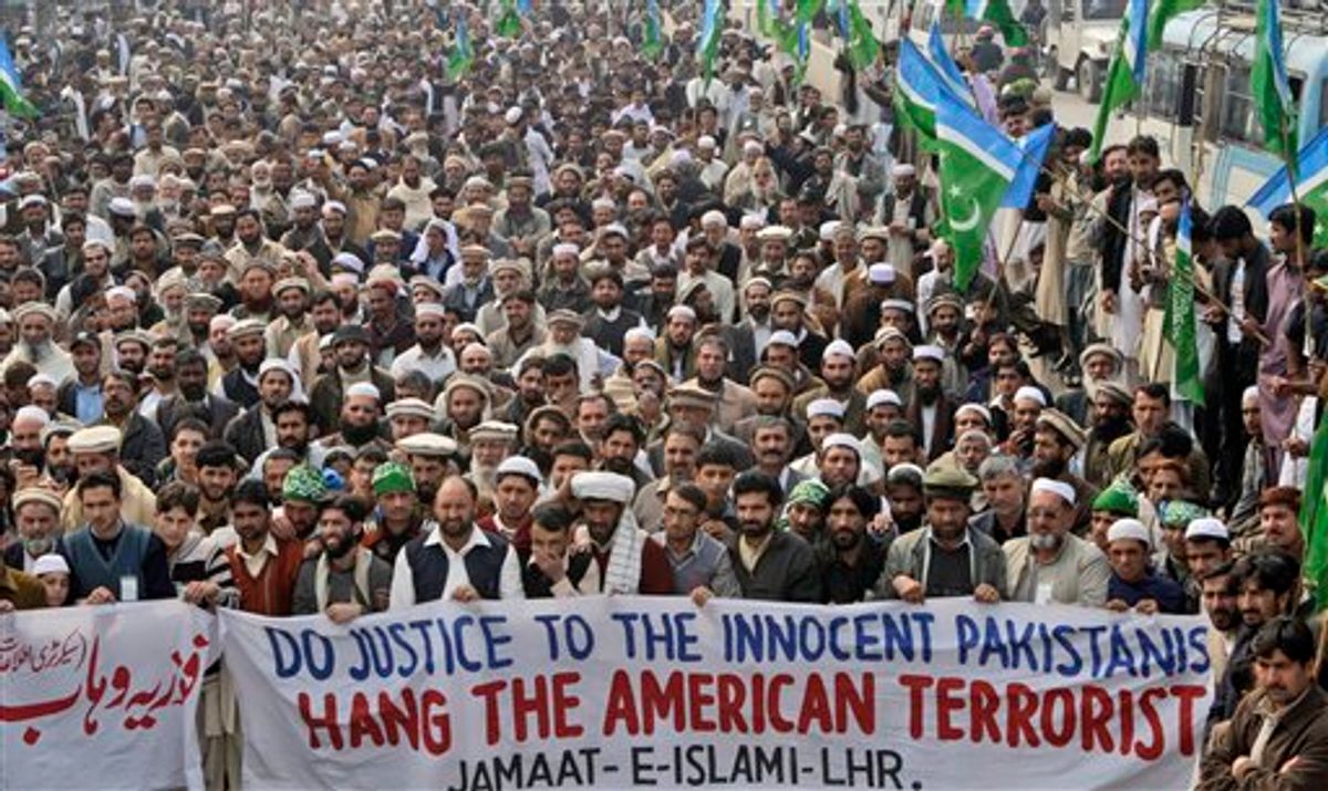Supporters of Pakistani religious party Jamat-e-Islami attend a rally against Raymond Allen Davis, a U.S. consulate employee suspected in a shooting, in Lahore, Pakistan, Tuesday, Feb. 15, 2011. Most legal experts in Pakistan's government believe an American detained in the killing of two Pakistanis has diplomatic immunity, but a court should decide his fate, an official said Tuesday. The announcement reflected an apparent bid to open the way to the man's release while dampening public outrage. (AP Photo/K.M. Chaudary) (AP)