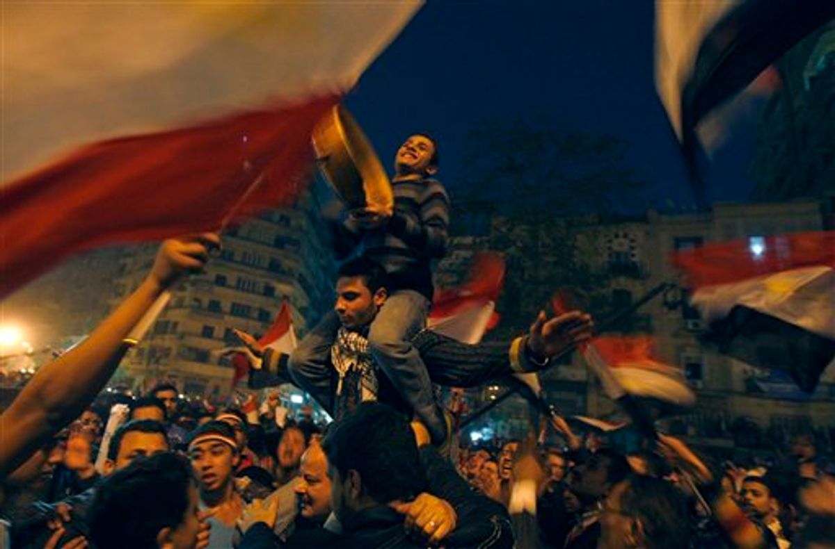 Demonstrators celebrate in Tahrir Square in Cairo, Egypt, Friday Feb. 18, 2011. Tens of thousands of flag-waving Egyptians packed into Tahrir Square for a day of prayer and celebration Friday to mark the fall Hosni Mubarak a week ago and to maintain pressure on the new military rulers to steer the country toward democratic reforms.(AP Photo/Khalil Hamra) (AP)