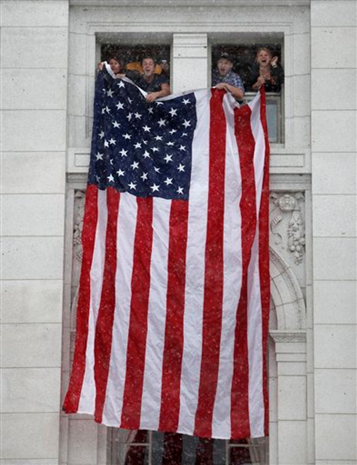 Rally supporters hang an American flag from fourth floor windows of the Wisconsin State Capitol Building as thousands of opponents of Governor Scott Walker's budget repair bill gather for ongoing protests inside and outside the State Capitol Building in Madison, Wisconsin Saturday, February 26, 2011. (AP Photos/Wisconsin State Journal, John Hart) (AP)