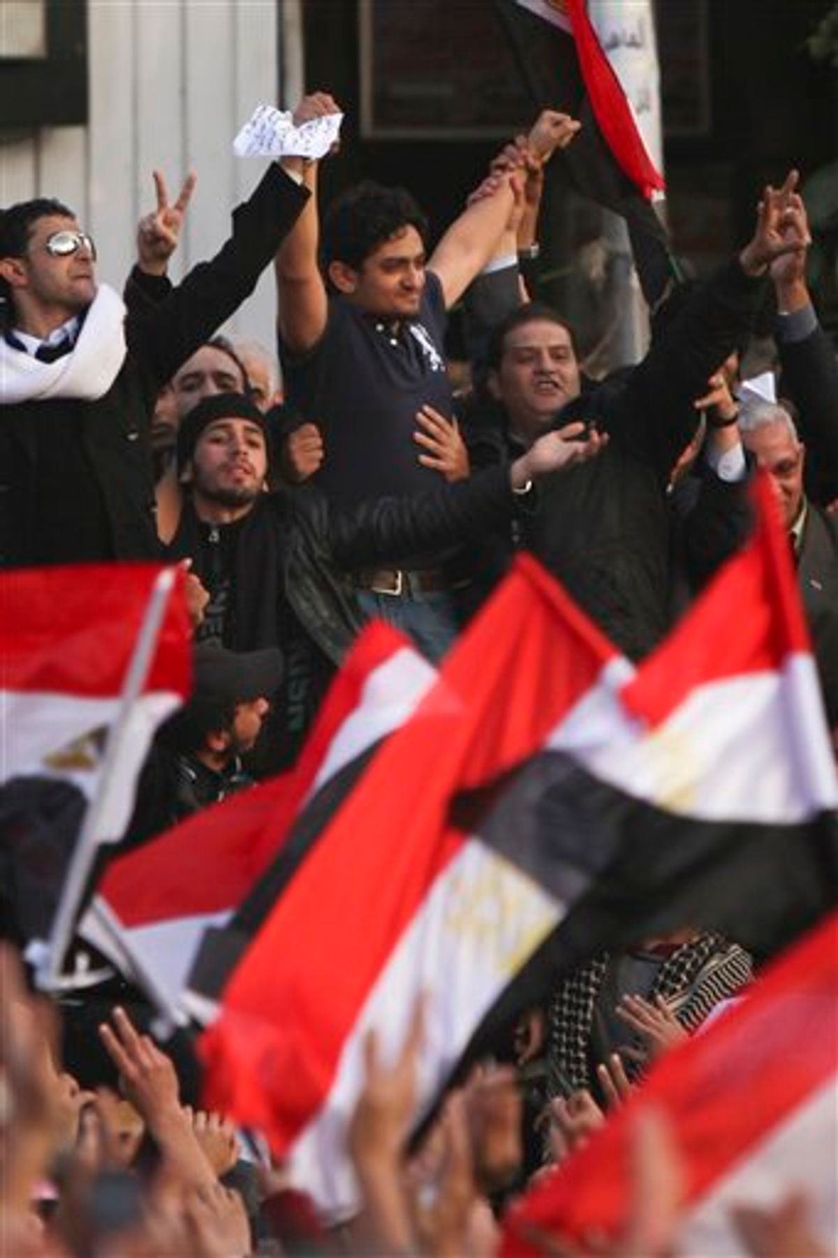 Egyptian Wael Ghonim, center, a 30-year-old Google Inc. marketing manager who was a key organizer of the online campaign that sparked the first protest on Jan. 25, gestures to the crowd in Tahrir Square, in Cairo, Egypt, Tuesday, Feb. 8, 2011. A young leader of Egypt's anti-government protesters, newly released from detention, joined a massive crowd of hundreds of thousands in Cairo's Tahrir Square for the first time Tuesday, greeted by cheers, whistling and thunderous applause when he declared: "We will not abandon our demand and that is the departure of the regime." (AP Photo/Tara Todras-Whitehill) (AP)