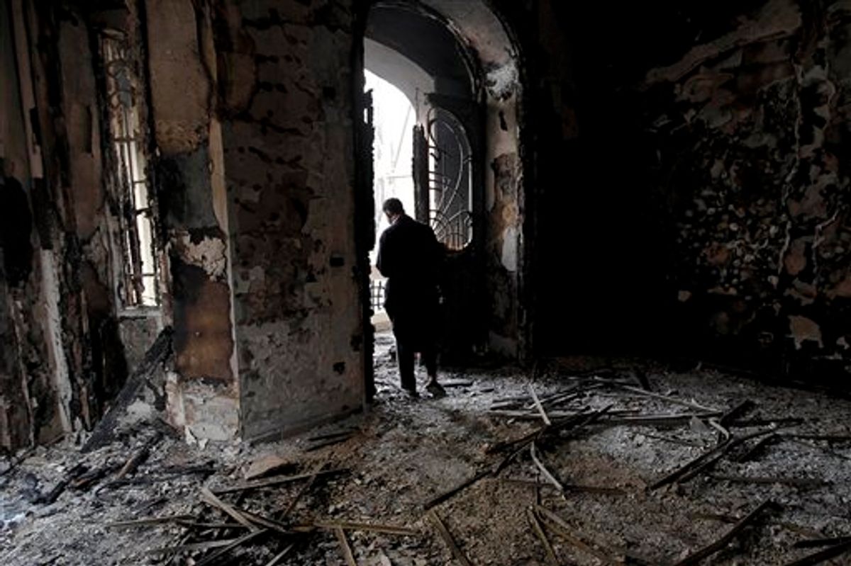 An Egyptian man surveys the fire damage at a burned and looted police station, in the Darb al Ahmar neighborhood of Cairo, Egypt, Saturday, Jan. 29, 2011. (AP Photo/Tara Todras-Whitehill)  (AP)
