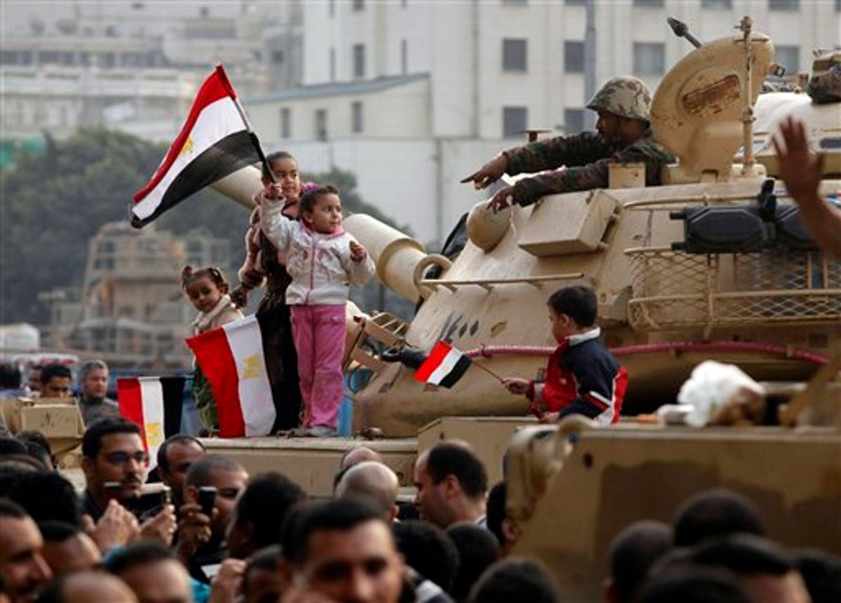 Young girls wave Egyptian flags atop an armored vehicle just outside Tahrir or Liberation Square in Cairo, Egypt, Tuesday, Feb. 1, 2011. More than a quarter-million people flooded into the heart of Cairo Tuesday, filling the city's main square in by far the largest demonstration in a week of unceasing demands for President Hosni Mubarak to leave after nearly 30 years in power. (AP Photo/Victoria Hazou) (AP)
