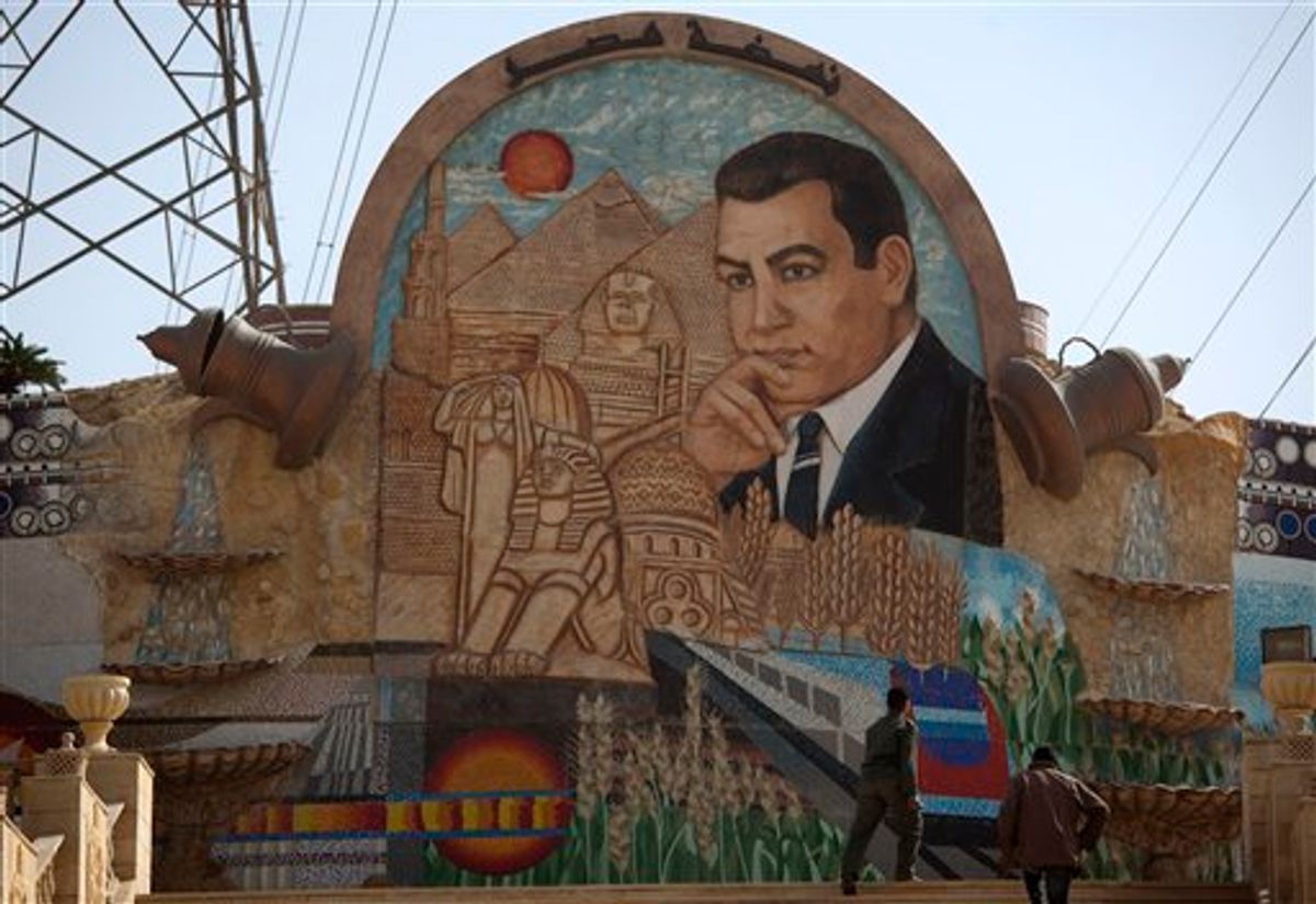 An Egyptian soldier walks up steps next to a stone mural with an image depicting former Egyptian President Hosni Mubarak on the outskirts of Cairo, Egypt, Tuesday Feb. 15, 2011.  On Tuesday, the Armed Forces Supreme Council said a panel of experts would craft constitutional amendments to allow free elections later this year. (AP Photo/Emilio Morenatti) (AP)