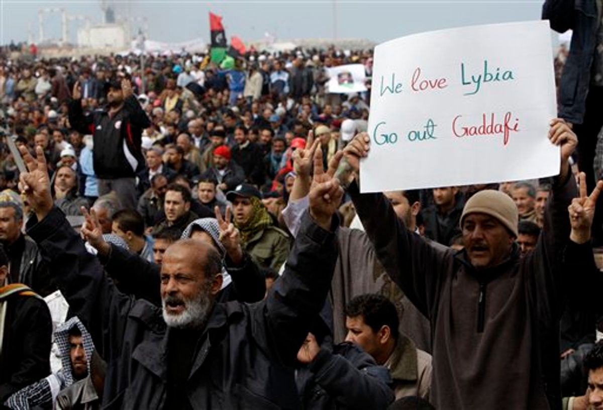 Libyan protesters shout slogans against Libyan Leader Moammar Gadhafi during a demonstration at the court square, in Benghazi, Libya, on Friday Feb. 25, 2011. Several tens of thousands held a rally in support of the Tripoli protesters in the main square of Libya's second-largest city, Benghazi, where the revolt began, about 580 miles (940 kilometers) east of the capital along the Mediterranean coast. (AP Photo/Hussein Malla) (AP)