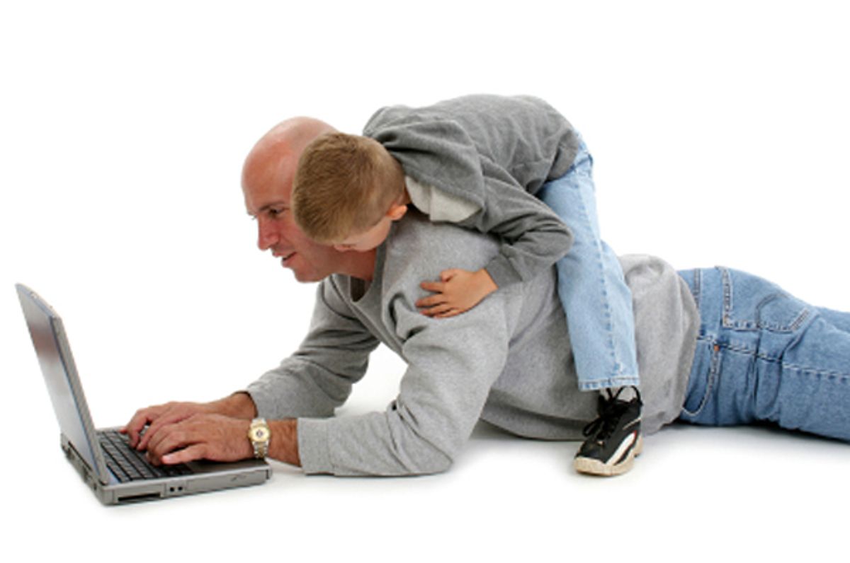 Four year old boy on his father's back while working on laptop. Shot over white.    (Jaimie D. Travis)