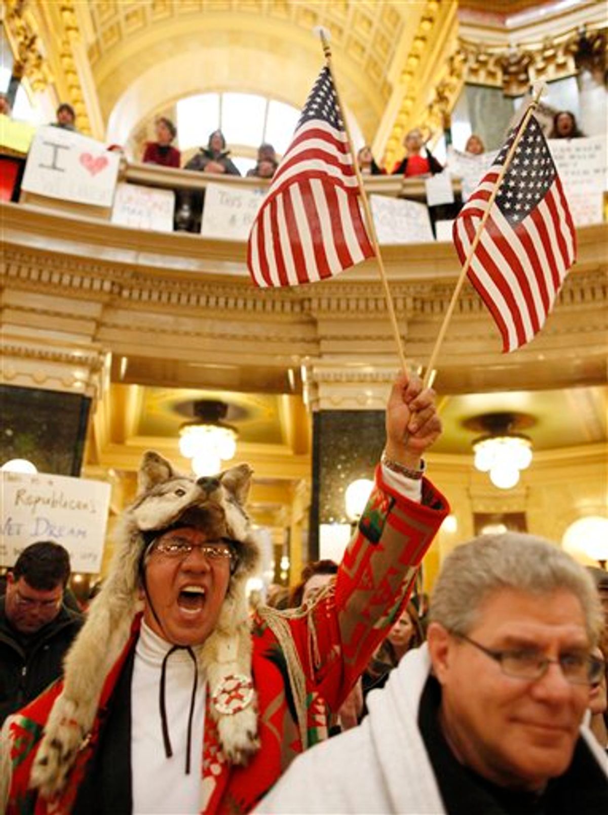 Arnold Chevalier, left, of Stoughton, Wis., shouts iinside the State Capitol Monday, Feb. 21, 2011, in Madison, Wis. Opponents to Governor Scott Walker's bill to eliminate collective bargaining rights for many state workers are taking part in their seventh day of protesting.  (AP Photo/Jeffrey Phelps)  (AP)
