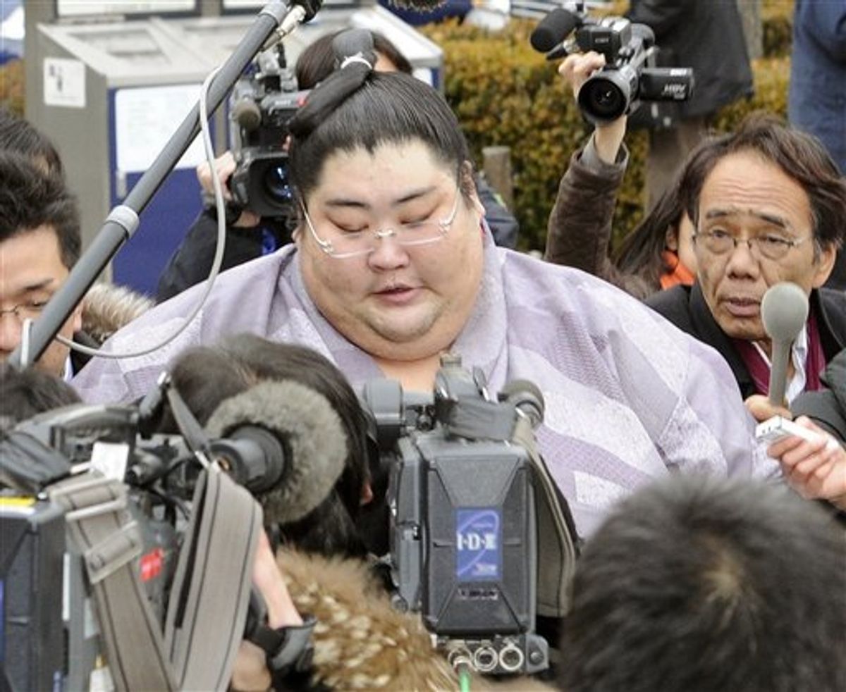 Sumo wrestler Yamamotoyama is surrounded by Japanese reporters after he was questioned by sumo elders in an emergency meeting at the Ryogoku Kokugikan sumo arena in Tokyo on Wednesday Feb. 2, 2011. Fresh off a gambling scandal that deeply sullied its image, Japan's national sport of sumo wrestling is now grappling with allegations that senior wrestlers and coaches used cell phones to plan how to fix bouts. (AP Photo/Kyodo News) JAPAN OUT, CREDIT MANDATORY, FOR COMMERCIAL USE ONLY IN NORTH AMERICA (AP)