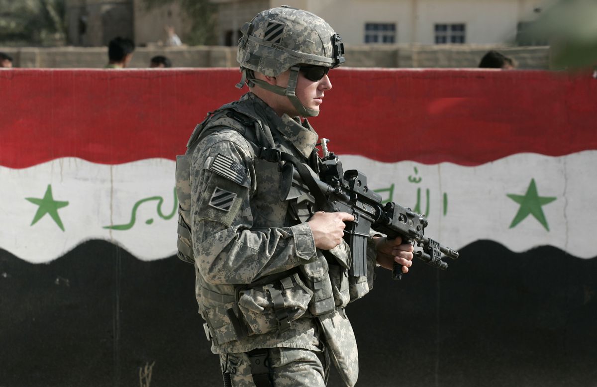 A U.S. soldier of Charlie Company 1-15 Infantry, 3rd Brigade Combat team, 3rd Infantry Division, passes next to a wall painted with the Iraqi flag during a routine patrol in Salman Pak, about 30 miles (45 kilometers) south of Baghdad, Iraq, Saturday, March 1, 2008. (AP Photo/Petros Giannakouris) (Associated Press)