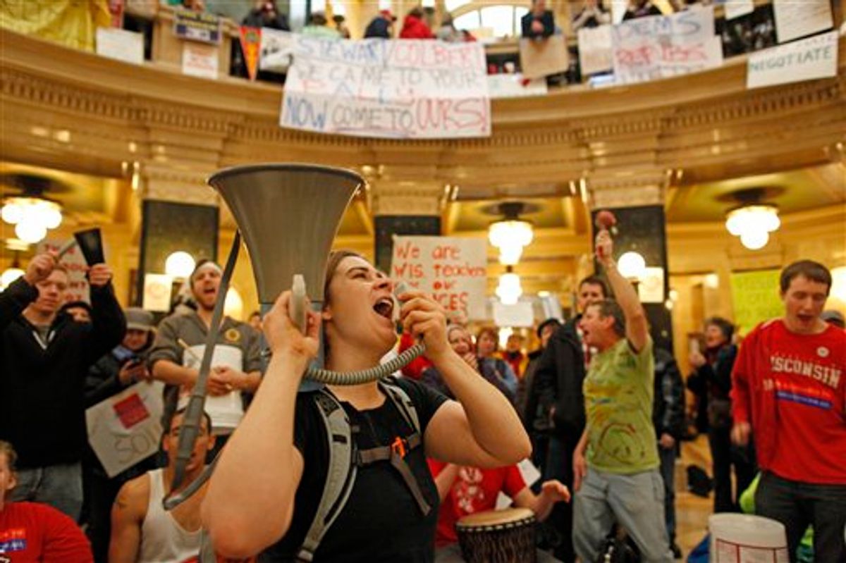 Protesters bang drums and shout slogans inside the state Capitol Monday, Feb. 21, 2011, in Madison, Wis. Opponents to Gov. Scott Walker's bill to eliminate collective bargaining rights for many state workers are taking part in their seventh day of protesting.  (AP Photo/Jeffrey Phelps) (AP)