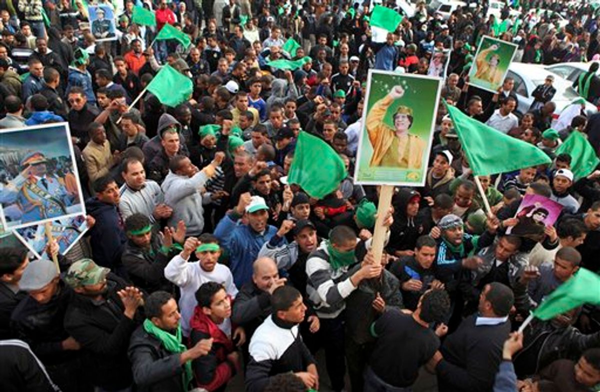 Pro-Gadhafi supporters gather in Green Square after traditional Friday prayers in Tripoli, Libya, Friday, Feb. 18, 2011. Protesters battled with security forces for control of neighborhoods Friday in eastern Libya where dozens have reportedly been killed in two days of clashes, as a leadership congress controlled by Moammar Gadhafi pledged a change in government adminstrators, trying to ease demonstrations demanding the longtime leader's ouster. (AP Photo/Abdel Meguid al-Fergany) (AP)
