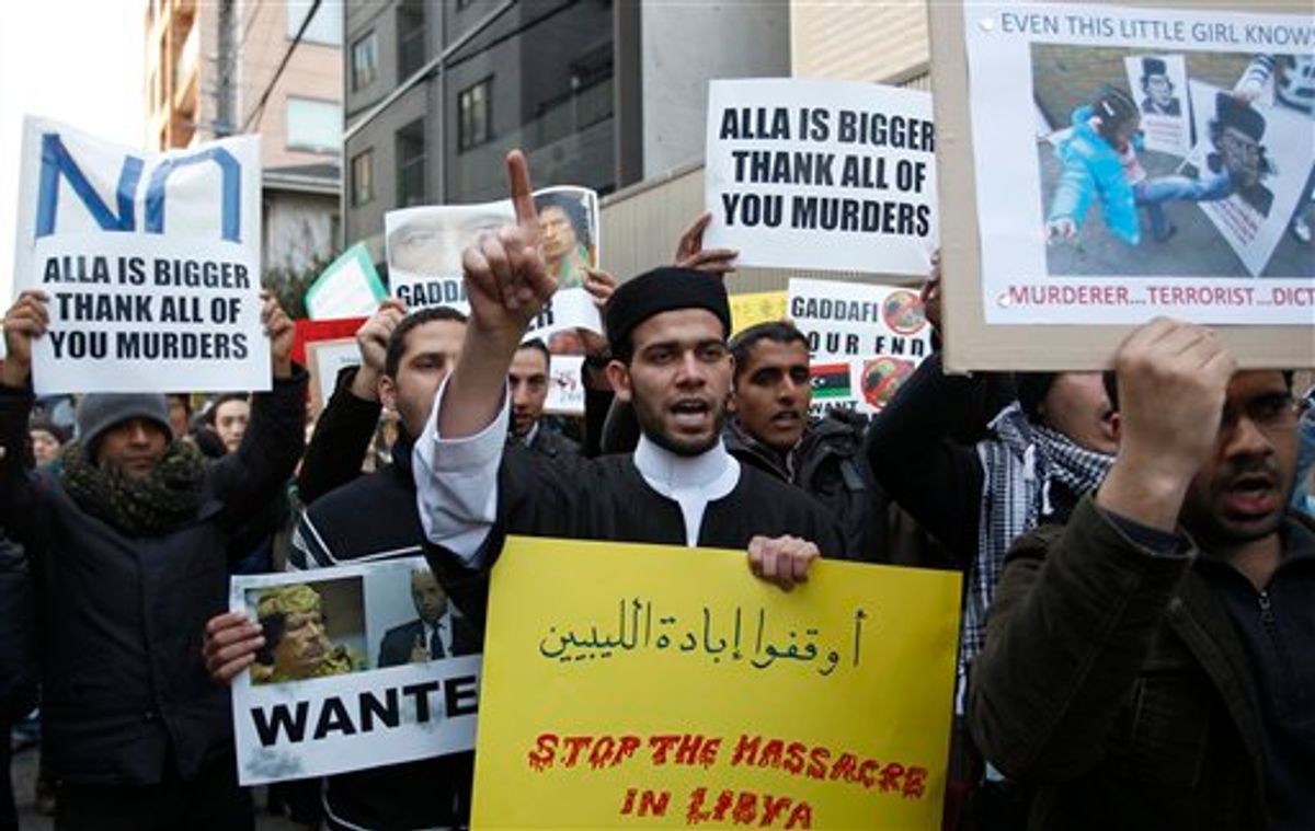 Libyans living in Japan and their supporters shout slogans against Libyan leader Moammar Gadhafi in front of the Libyan embassy in Tokyo, on Wednesday, Feb. 23, 2011. (AP Photo/Shizuo Kambayashi) (AP)