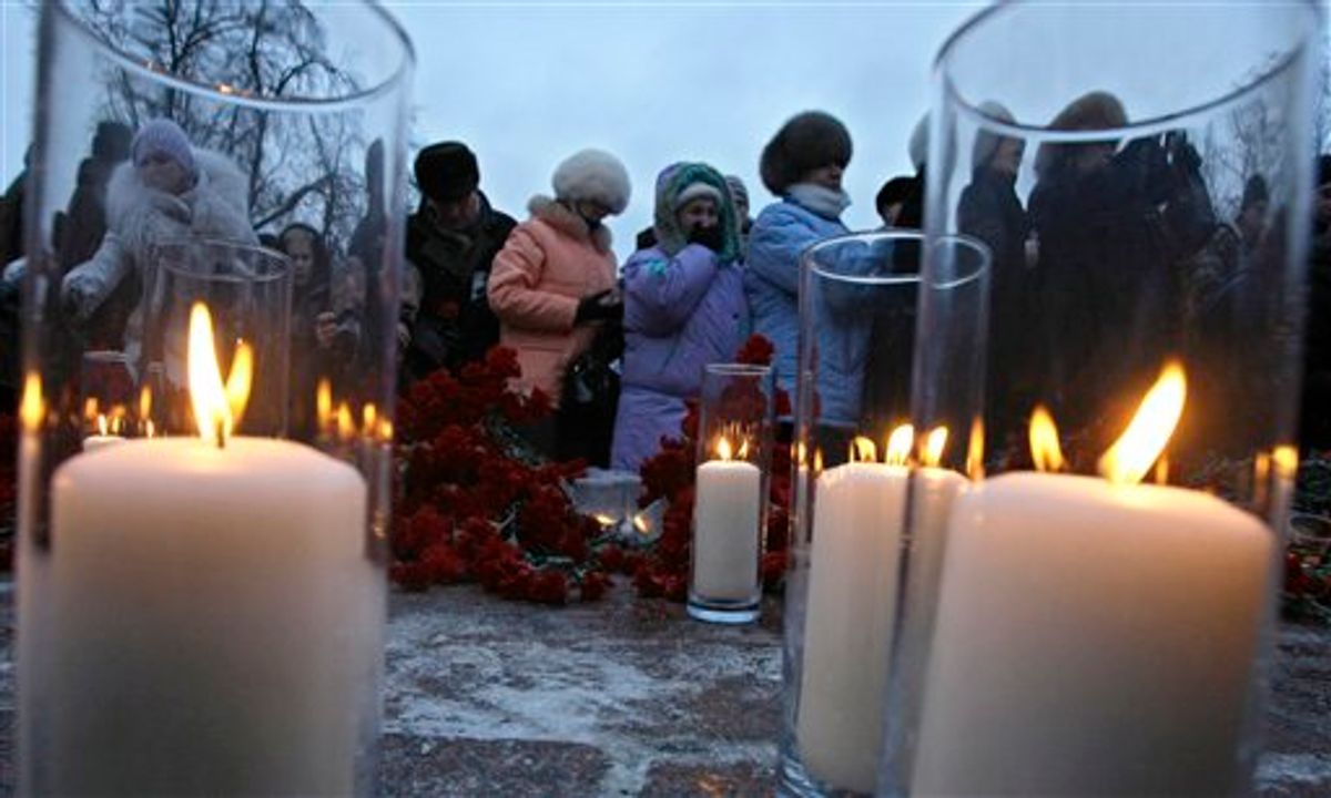 People light candles and place flowers, mourning victims of the  deadly bombing at a Moscow airport during a commemoration rally in downtown Moscow, Russia, Thursday, Jan. 27, 2011. A suicide bomber set off an explosion that ripped through Moscow's busiest airport on Monday, killing dozens of people and wounding more than a hundred. (AP Photo/Misha Japaridze)  (AP)