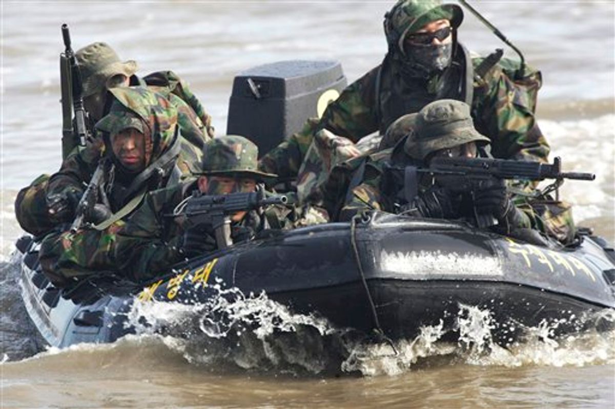 FILE - In this Feb. 25, 2011 file photo, South Korean marines on an inflatable boat aim their machine guns during a military exercise to prepare for a possible North Korea's surprise attack on the Han River in Gimpo, South Korea. North Korea's military threatened Sunday, Feb. 27, 2011 to fire at South Korea, as Seoul prepared to start annual joint drills with U.S. troops, maneuvers Pyongyang says are a rehearsal for an invasion. (AP Photo/Ahn Young-joon, File) (AP)