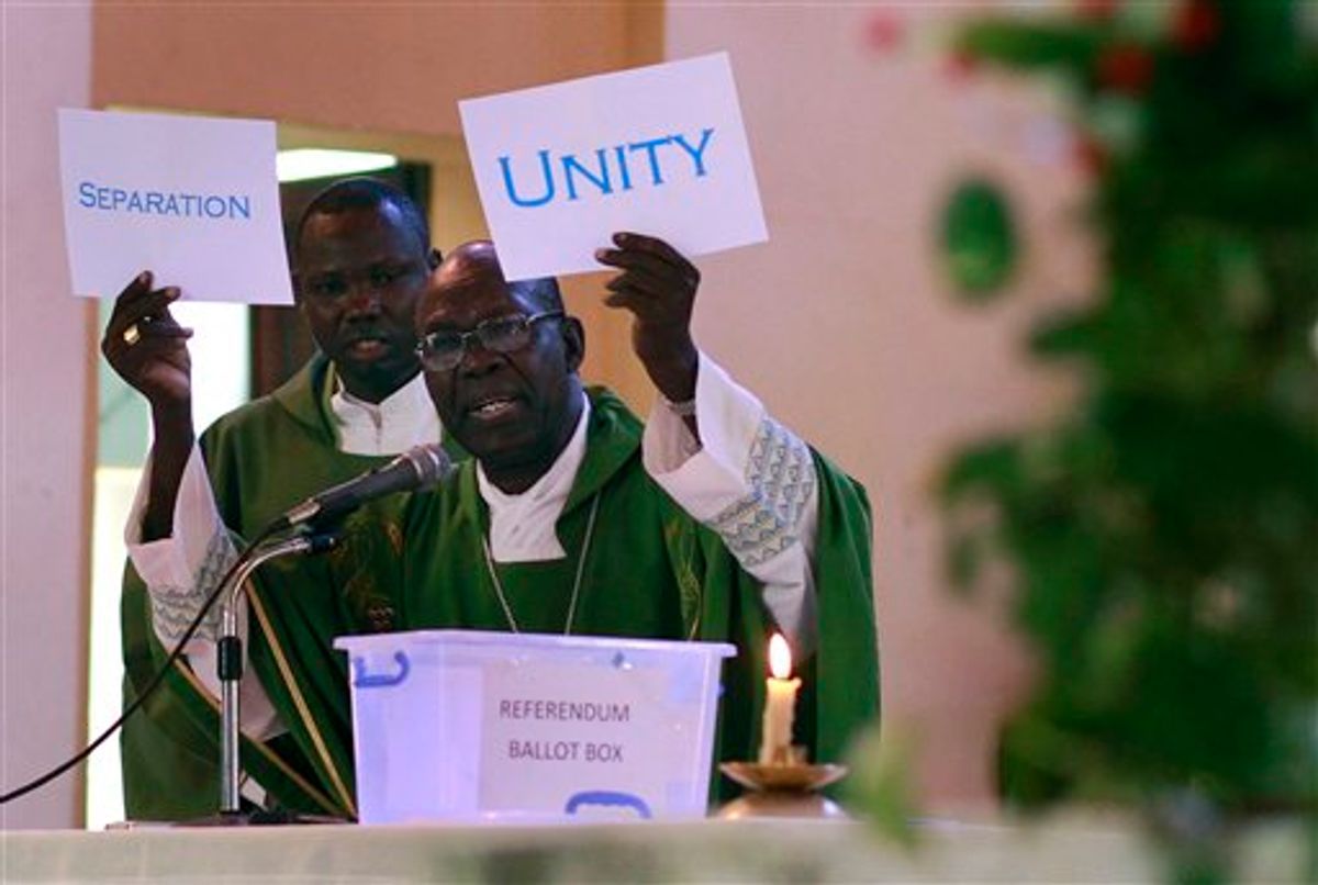 South Sudanese Catholic Archbishop Paulino Lukudu holds up mock ballots during a service attended by President Salva Kiir in  Juba, Southern Sudan, Sunday  Jan. 16, 2011. The Southern Sudan's president on Sunday offered a prayer of forgiveness for northern Sudan and the killings that occurred during a two-decade civil war, as the first results from a weeklong independence referendum showed an overwhelming vote for secession. About four million  Southern Sudanese voters cast their ballots  in a weeklong referendum on independence that is expected to split Africa's largest nation in two.(AP Photo/Jerome Delay)  (AP)