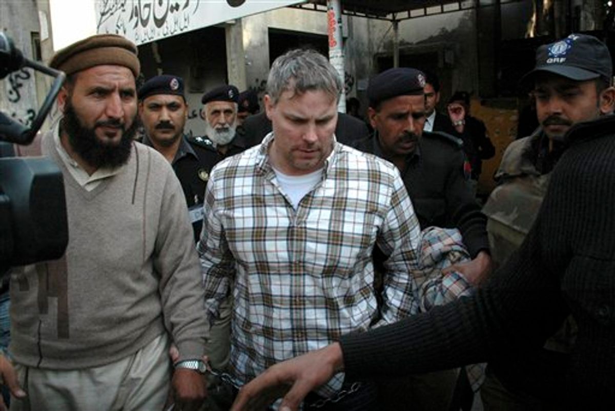 FILE - In this Jan. 28, 2011 file photo, Pakistani security officials escort Raymond Allen Davis, a U.S., center, to a local court in Lahore, Pakistan. The Associated Press has learned that an American jailed in Pakistan after the fatal shooting of two armed men was secretly working for the CIA.  The arrest last month of 36-year-old Raymond Allen Davis has caused an international diplomatic crisis. The U.S. has repeatedly asserted that Davis had diplomatic immunity and should have been released immediately.  But former and current U.S. officials, who spoke on condition of anonymity because they weren't authorized to talk publicly about the incident, told the AP that Davis had been working as a CIA security contractor for the U.S. consulate in Lahore. (AP Photo/Hamza Ahmed, File) (AP)