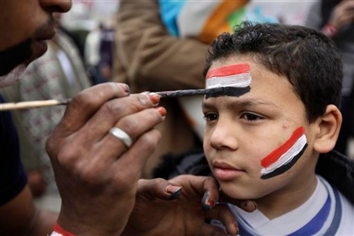 A young anti-government protester has his face painted in the colors of the Egyptian flag at the continuing protest in Tahrir Square in downtown Cairo, Egypt, Monday, Feb. 7, 2011. Egypt's embattled regime announced Monday a 15 percent raise for government employees in an attempt to shore up its base and defuse popular anger but the gestures so far have done little to persuade the tens of thousands of protesters occupying Tahrir Square to end their two-week long protest, leaving the two sides in an uneasy stalemate. (AP Photo/Ben Curtis) (AP)