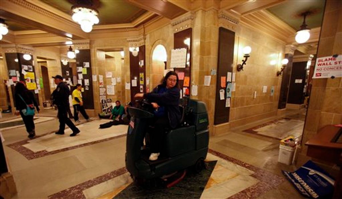 A custodian washes the floor of the at the state Capitol in Madison, Wis., Sunday, Feb. 27, 2011., on the 13th day of protests over the governor's proposed budget. (AP Photo/Andy Manis)          (AP)