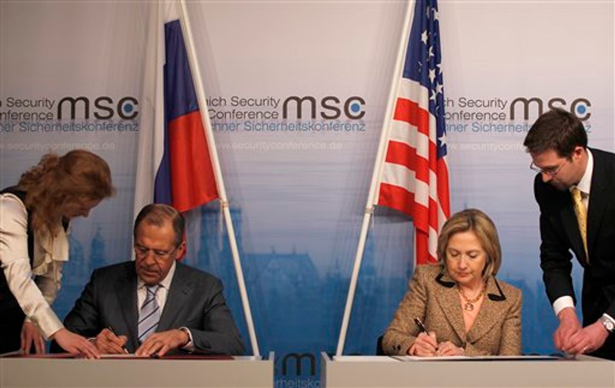 US Secretary of State Hillary Rodham Clinton, right, and Russia's Foreign Minister Sergey Lavrov finalize the New START treaty  during the Conference on Security Policy in Munich, Germany, Saturday, Feb. 5, 2011.   (AP Photo/Frank Augstein) (AP)