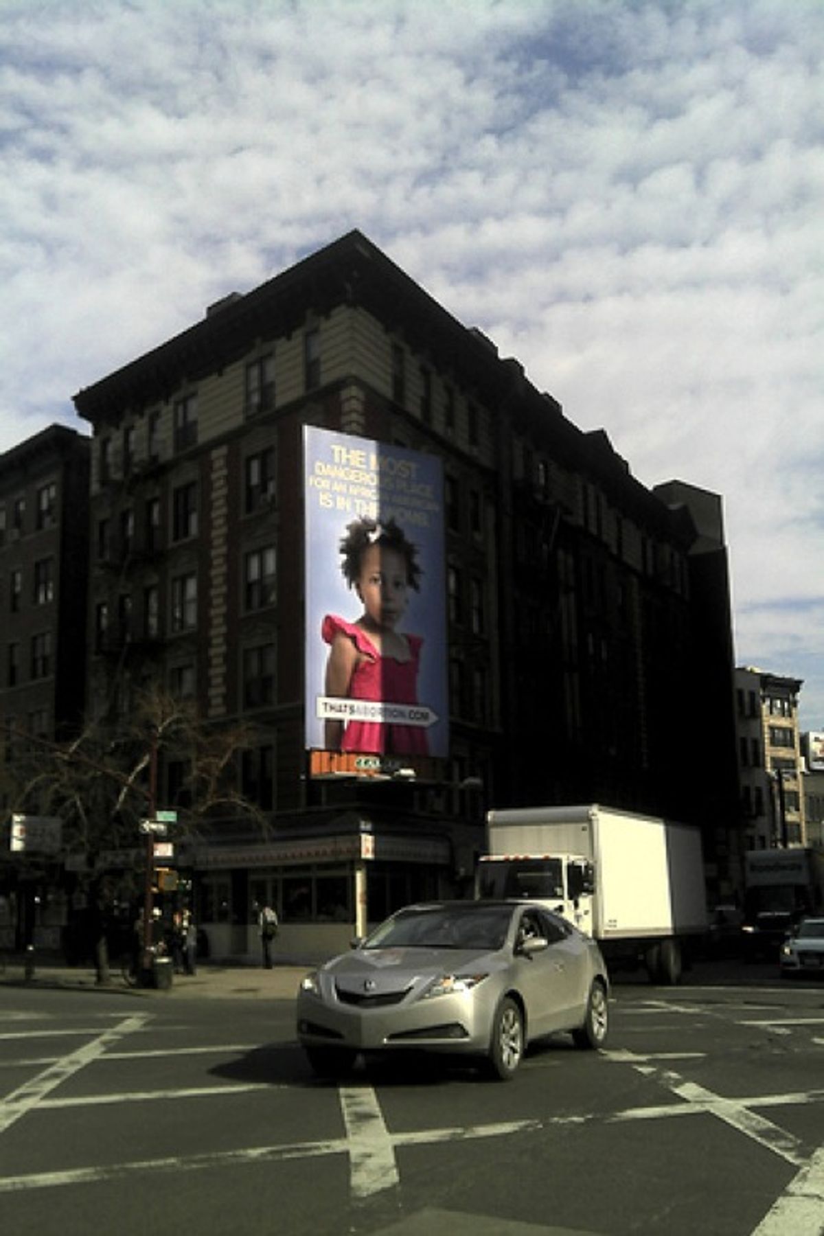 The anti-abortion billboard stands at the corner of 6th street in SoHo