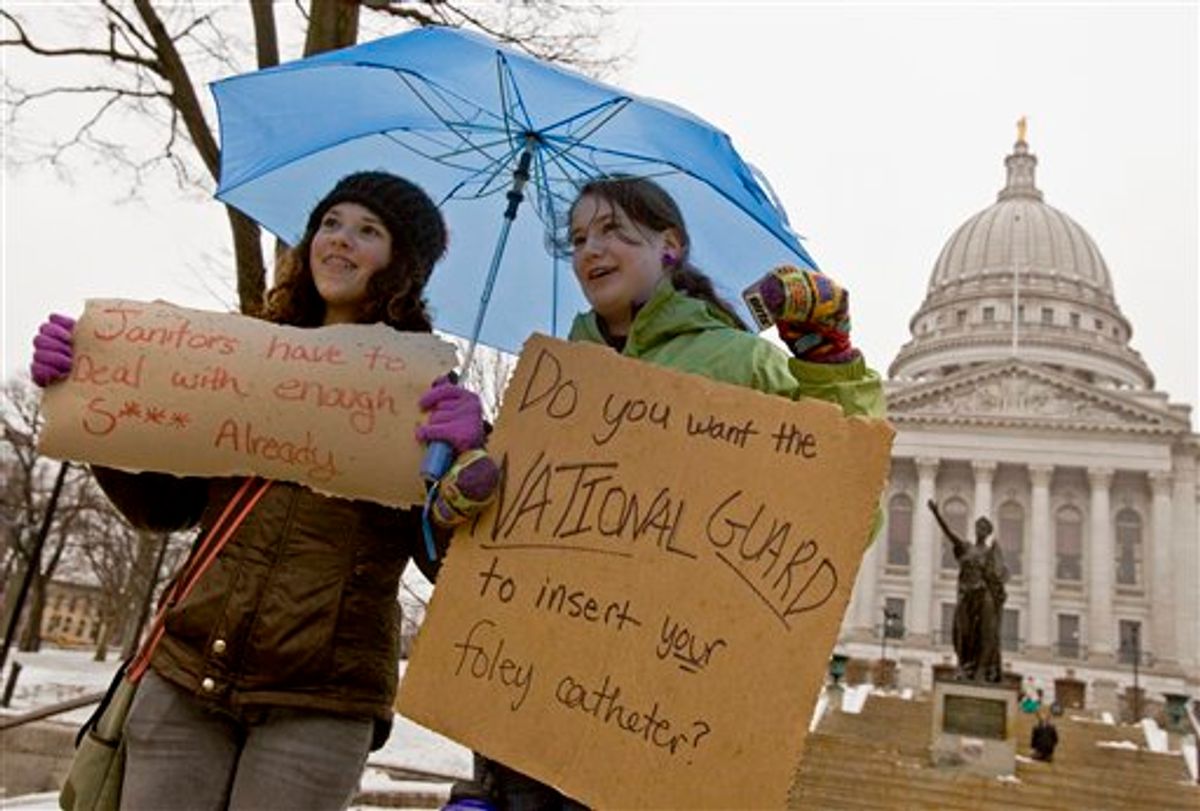 Jane Moran, left, 14, and Emma Rankin-Utevsky, 14, protest outside of at the State Capitol in Madison, Wis., Sunday, Feb. 20, 2011. Opponents to the governor's bill to eliminate collective bargaining rights for many state workers are on their sixth day of protesting. (AP Photo/Andy Manis)  (AP)