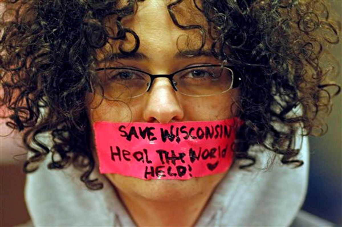 Kathryn Schulze wears a message written on tape over her mouth inside the state Capitol Monday, Feb. 21, 2011, in Madison, Wis. Opponents to Governor Scott Walker's bill to eliminate collective bargaining rights for many state workers are taking part in their seventh day of protesting. (AP Photo/Jeffrey Phelps)  (AP)
