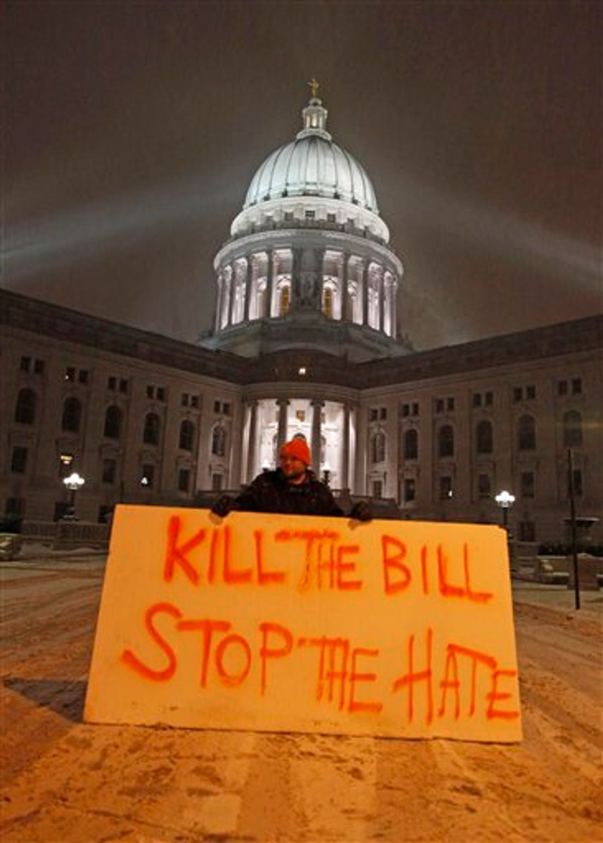 Luke Balsavich holds a large sign outside the state Capitol Monday, Feb. 21, 2011, in Madison, Wis. Opponents to Governor Scott Walker's bill to eliminate collective bargaining rights for many state workers are taking part in their seventh day of protesting.  (AP Photo/Jeffrey Phelps)  (AP)