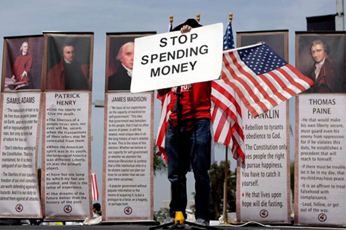 Michael Fell, of Culver City, Calif., holds up a sign reading "STOP SPENDING MONEY" as he speaks at a tea party rally in Irvine, Calif., Thursday, April 15, 2010. (AP Photo/Jae C. Hong) (Jae C. Hong)