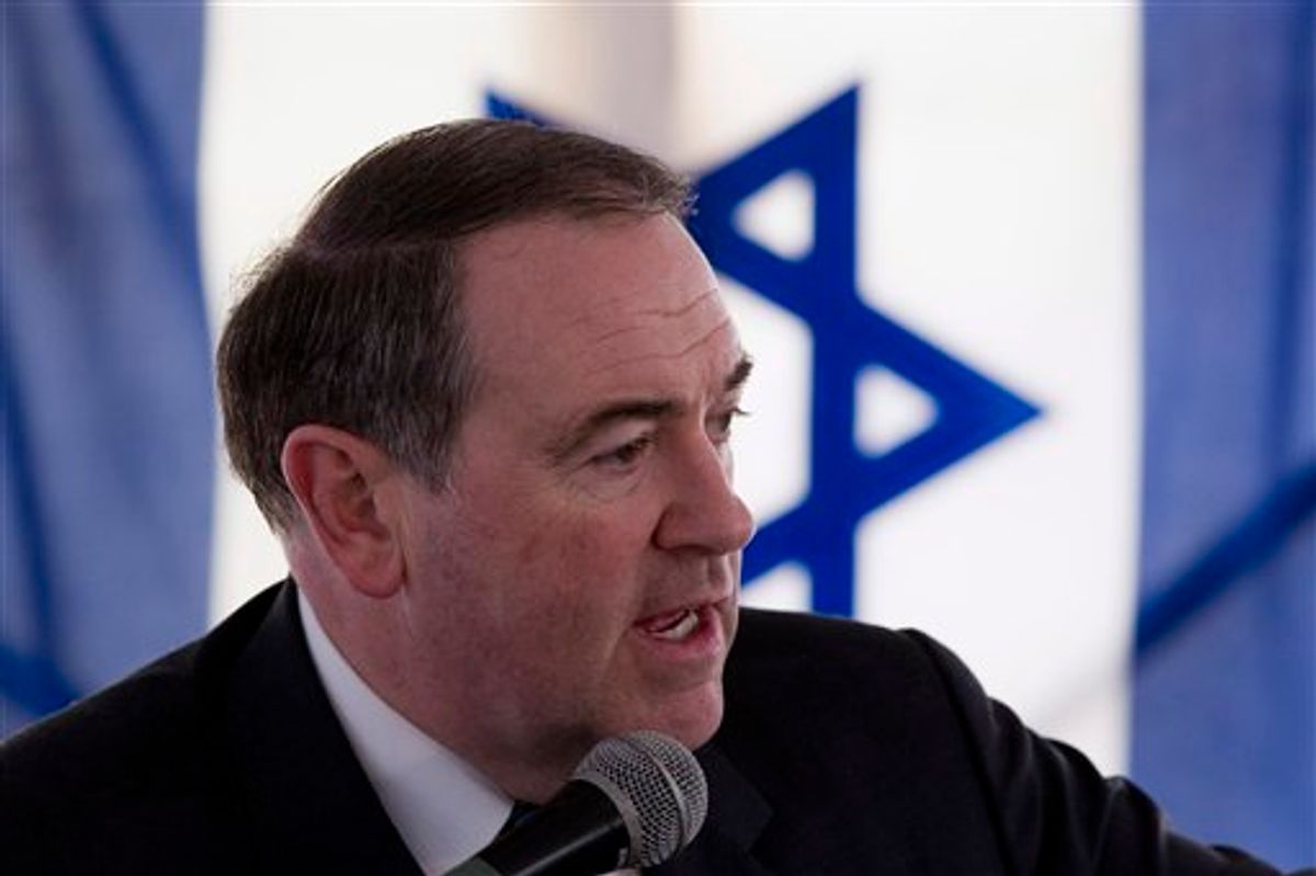 With an Israeli flag in the background, former Arkansas Gov. and Republican presidential contender Mike Huckabee speaks in Beit Oron, east Jerusalem, Monday, Jan. 31, 2011. Likely 2012 U.S. presidential contender Mike Huckabee says preventing Jewish settlers from building in east Jerusalem is as outrageous as discriminating against Americans because of their race, language or religion. Huckabee spoke at the dedication of a new Jewish neighborhood in east Jerusalem, which is claimed by the Palestinians. (AP Photos/Bernat Armangue) (AP)