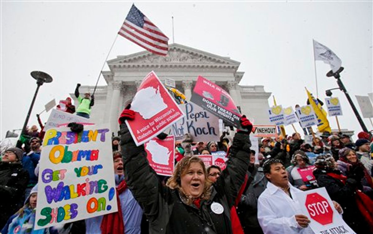 Teacher Kristen Henningfeld, center, of Elk Mound, Wis., protests on the steps of the state Capitol in Madison, Wis., Saturday, Feb. 26, 2011. Protests to the governor's bill to eliminate collective bargaining rights for many state workers are in their 12th day. (AP Photo/Andy Manis) (AP)
