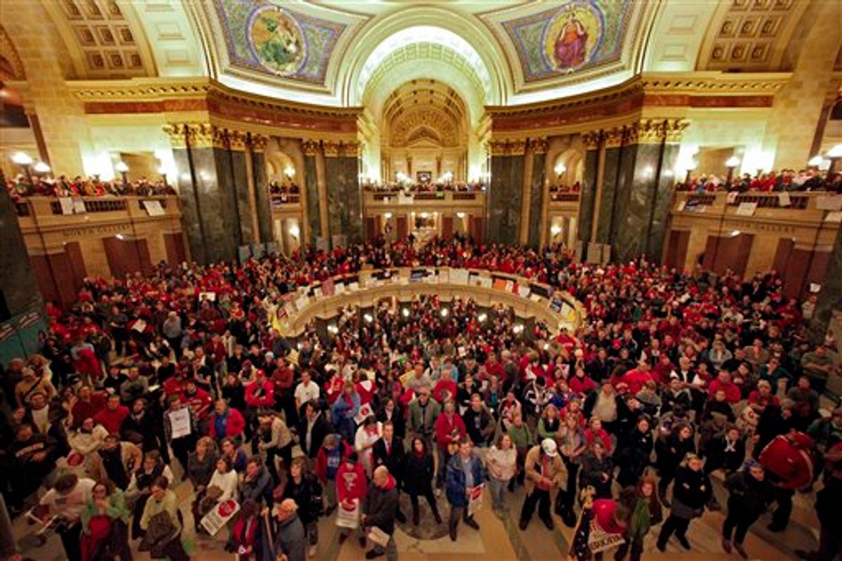 Protestors to Wisconsin Gov. Scott Walker's proposal to eliminate collective bargaining rights for many state workers listen in the rotunda at the State Capitol in Madison, Wis., Wednesday, Feb. 16, 2011, to testimony during a Joint Finance Committee meeting . (AP Photo/Andy Manis) (AP)