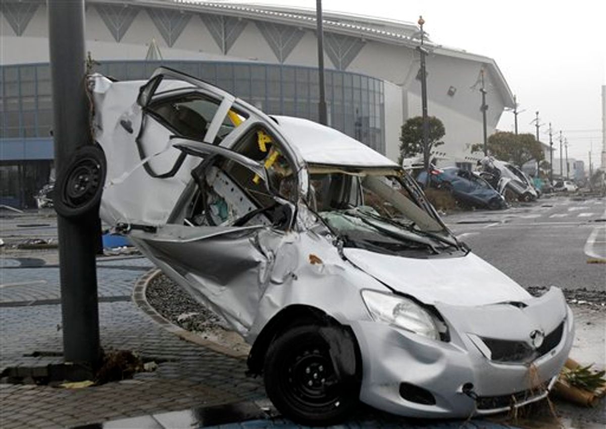 Wreckage of Toyota Yaris compact sedans, export model for North America destroyed by the March 11 earthquake and tsunami, remain at a Sendai port, Japan, Tuesday, March 15, 2011. (AP Photo/Koji Sasahara) (AP)