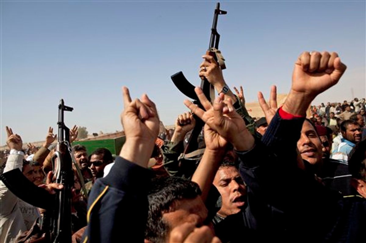 Libyan relatives of rebel fighters killed in fighting with troops loyal to Libyan leader Moammar Gadhafi on Wednesday, react during a mass funeral in Ajdabiya, eastern Libya, Thursday, March 3, 2011. (AP Photo/Kevin Frayer) (AP)