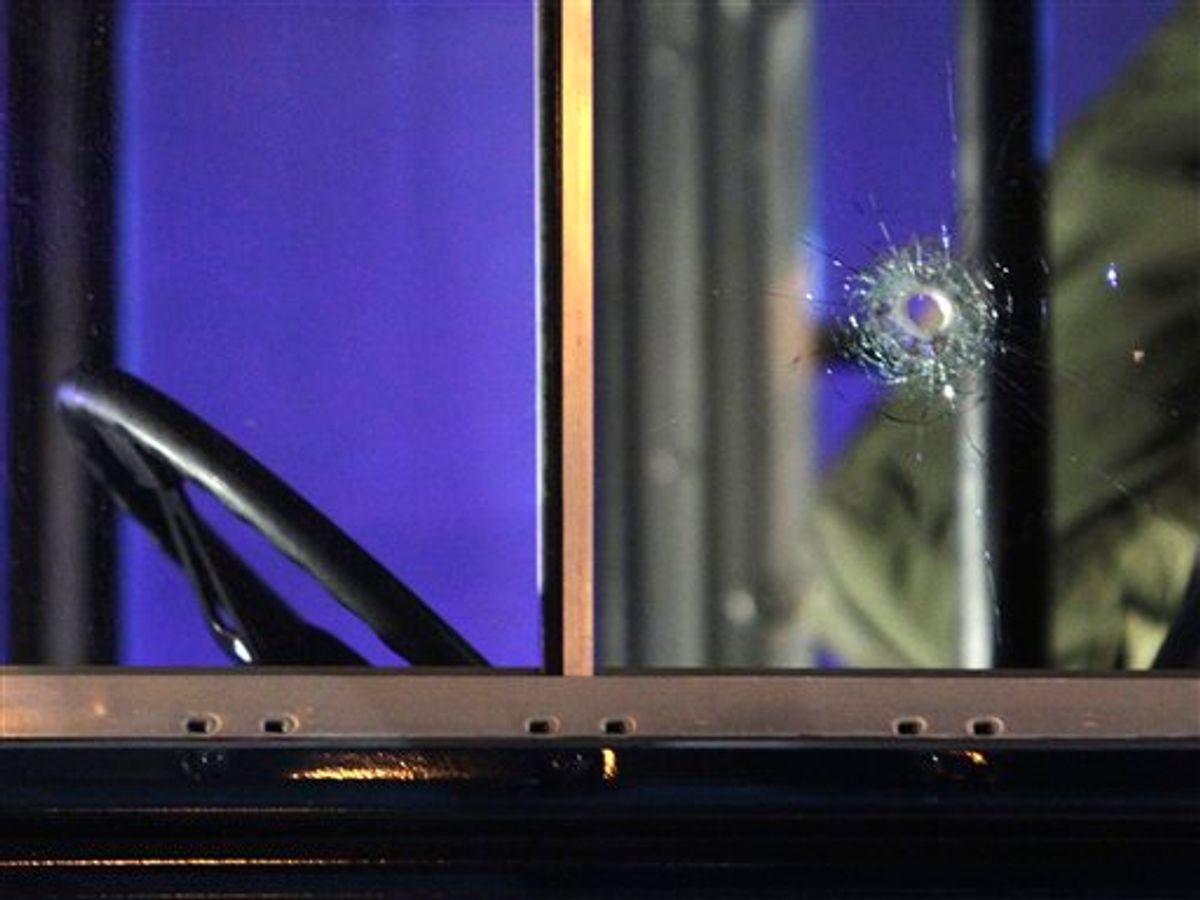A bullet hole is seen in the driver's window as the bus is towed away after a gunman fired shots at U.S. soldiers on the bus outside Frankfurt airport, Germany, Wednesday, March 2, 2011 killing two airmen and wounding two before being taken into custody. (AP Photo/Michael Probst) (AP)
