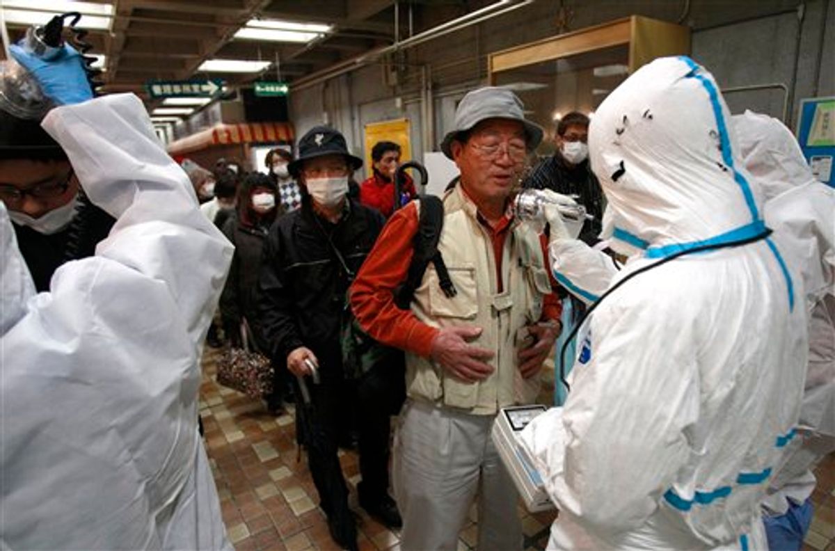 An evacuee is screened for radiation exposure at a testing center Tuesday, March 15, 2011, in Koriyama city, Fukushima prefecture, Japan, after a nuclear power plant on the coast of the prefecture was damaged by Friday's earthquake. (AP Photo/Wally Santana) (AP)