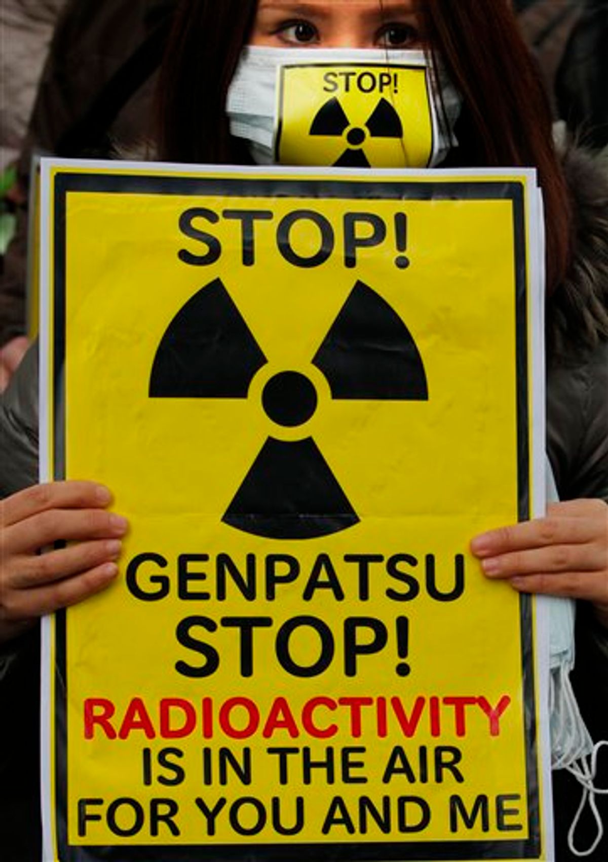A protester holds a placard during an antinuclear rally in Tokyo Sunday, March 27, 2011. Leaked water in Unit 2 of the Fukushima Dai-ichi plant measured 10 million times higher than usual radioactivity levels when the reactor is operating normally, Tokyo Electric Power Co. spokesman Takashi Kurita told reporters in Tokyo. "Genpatsu" on the sign means "nuclear power plant." (AP Photo/Itsuo Inouye) (AP)